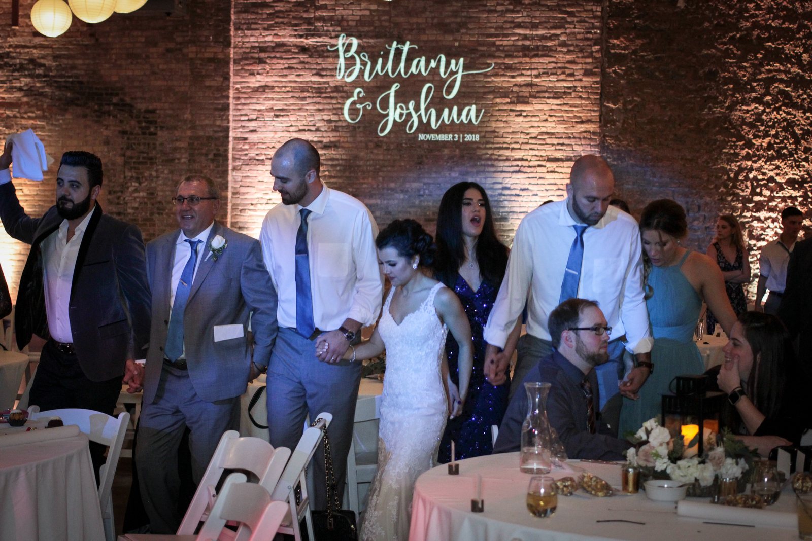 Wedding reception entrance with monogram and uplighting